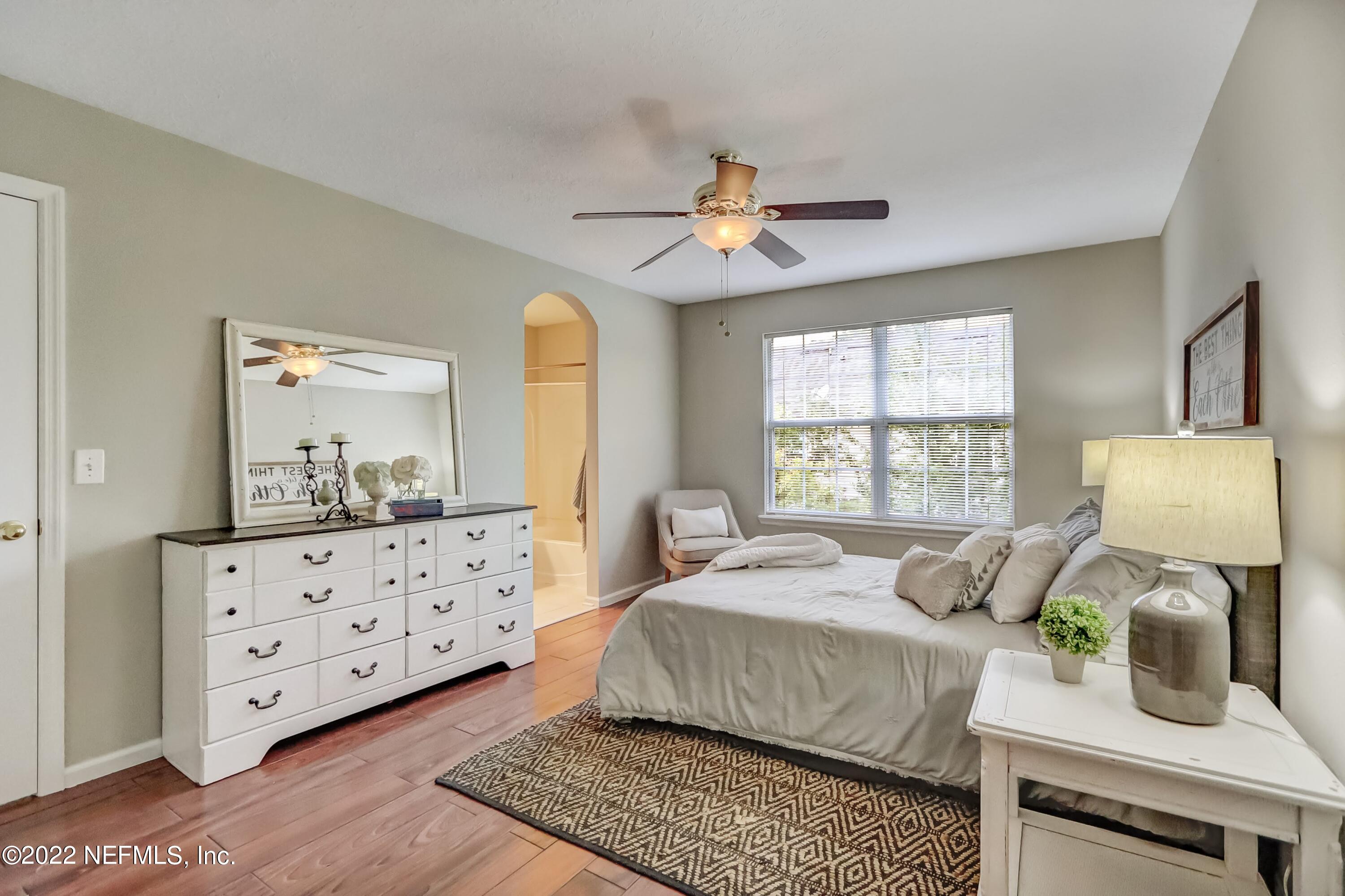 6849 Misty View Drive Jacksonville, FL 32210 - Photo 15 of 21 a bedroom with a bed a window dresser and mirror