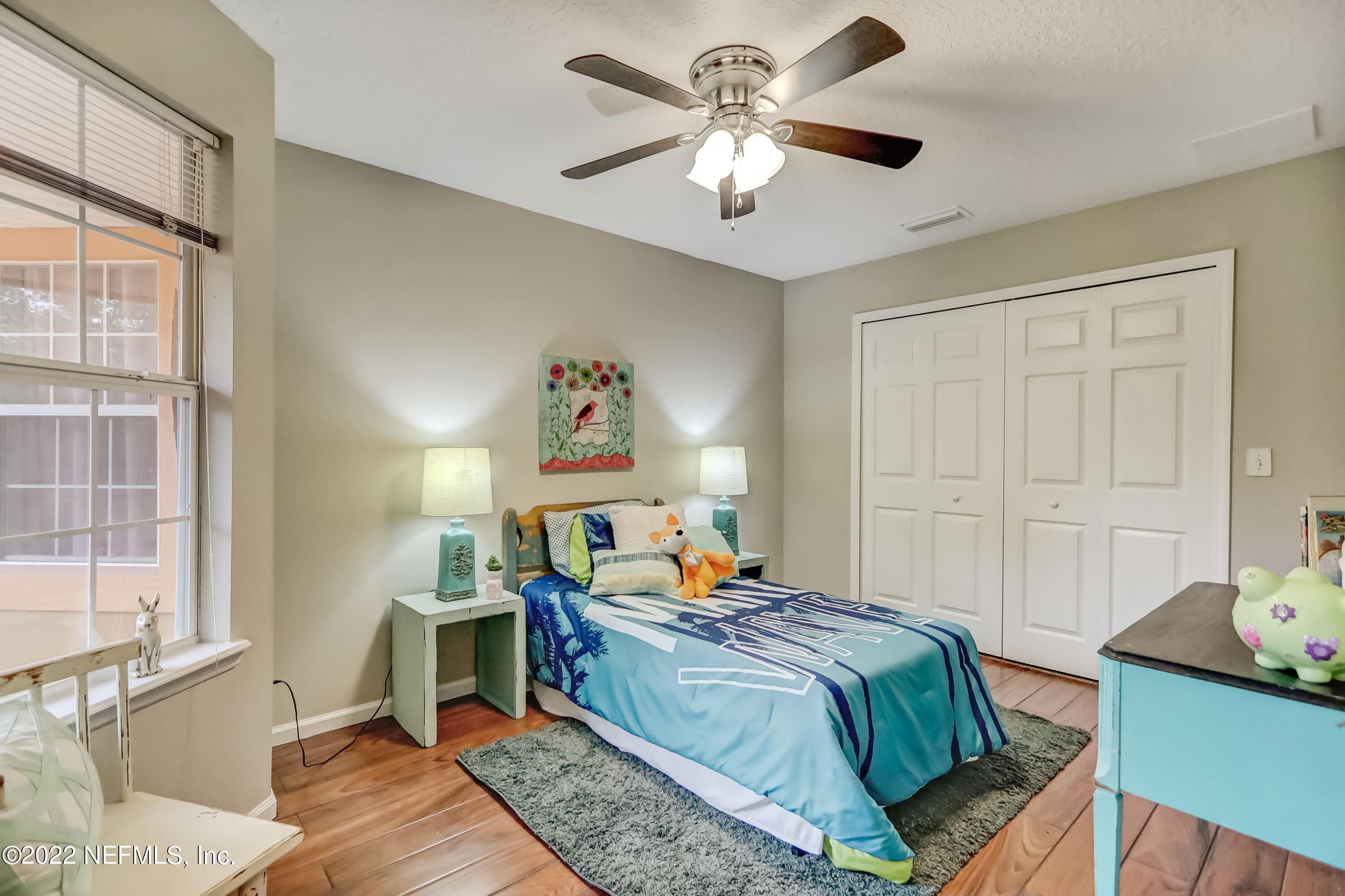 6849 Misty View Drive Jacksonville, FL 32210 - Photo 17 of 21 a bedroom with a bed and a chandelier