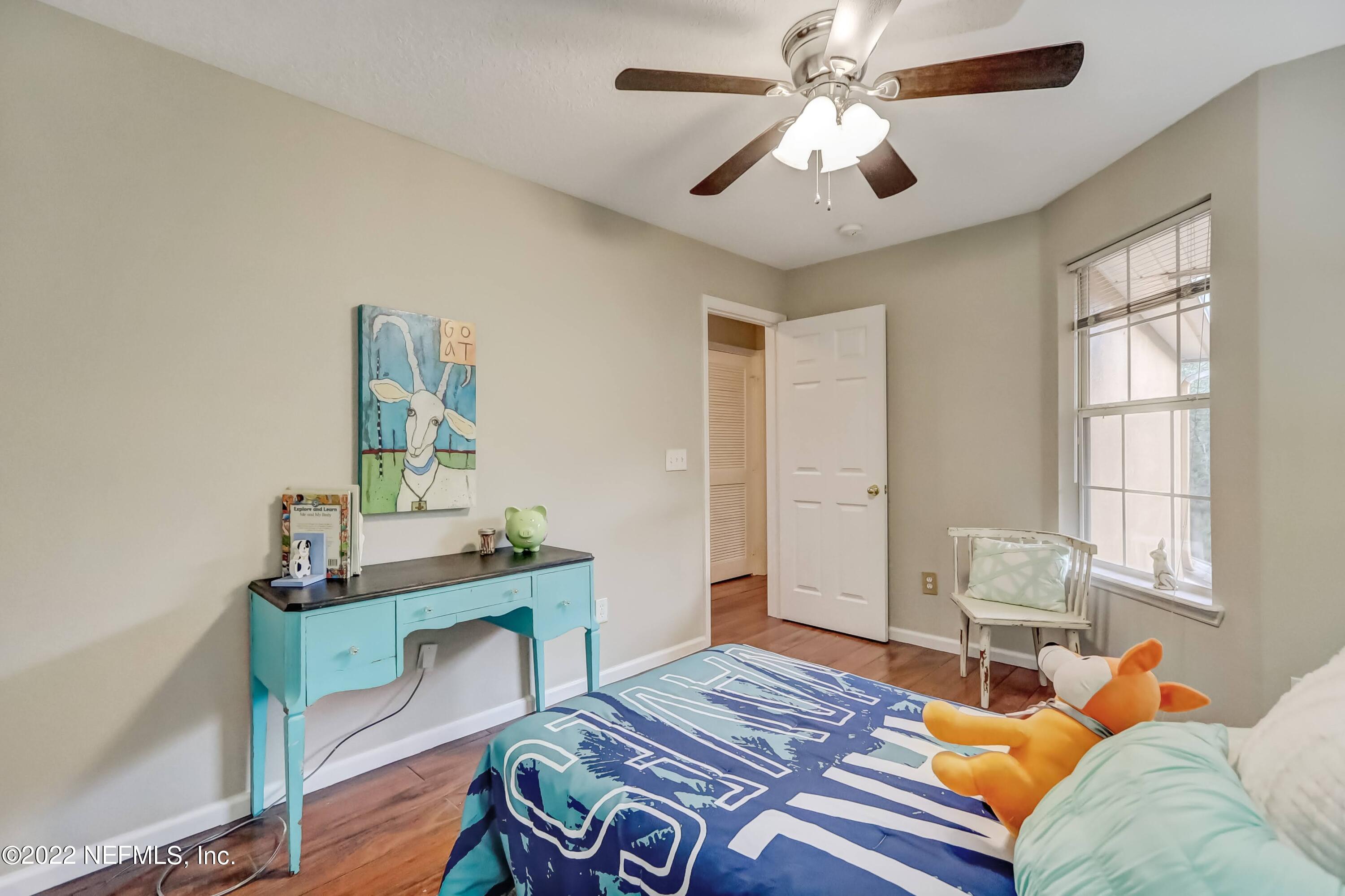 6849 Misty View Drive Jacksonville, FL 32210 - Photo 18 of 21 a bedroom with a bed and a table in it