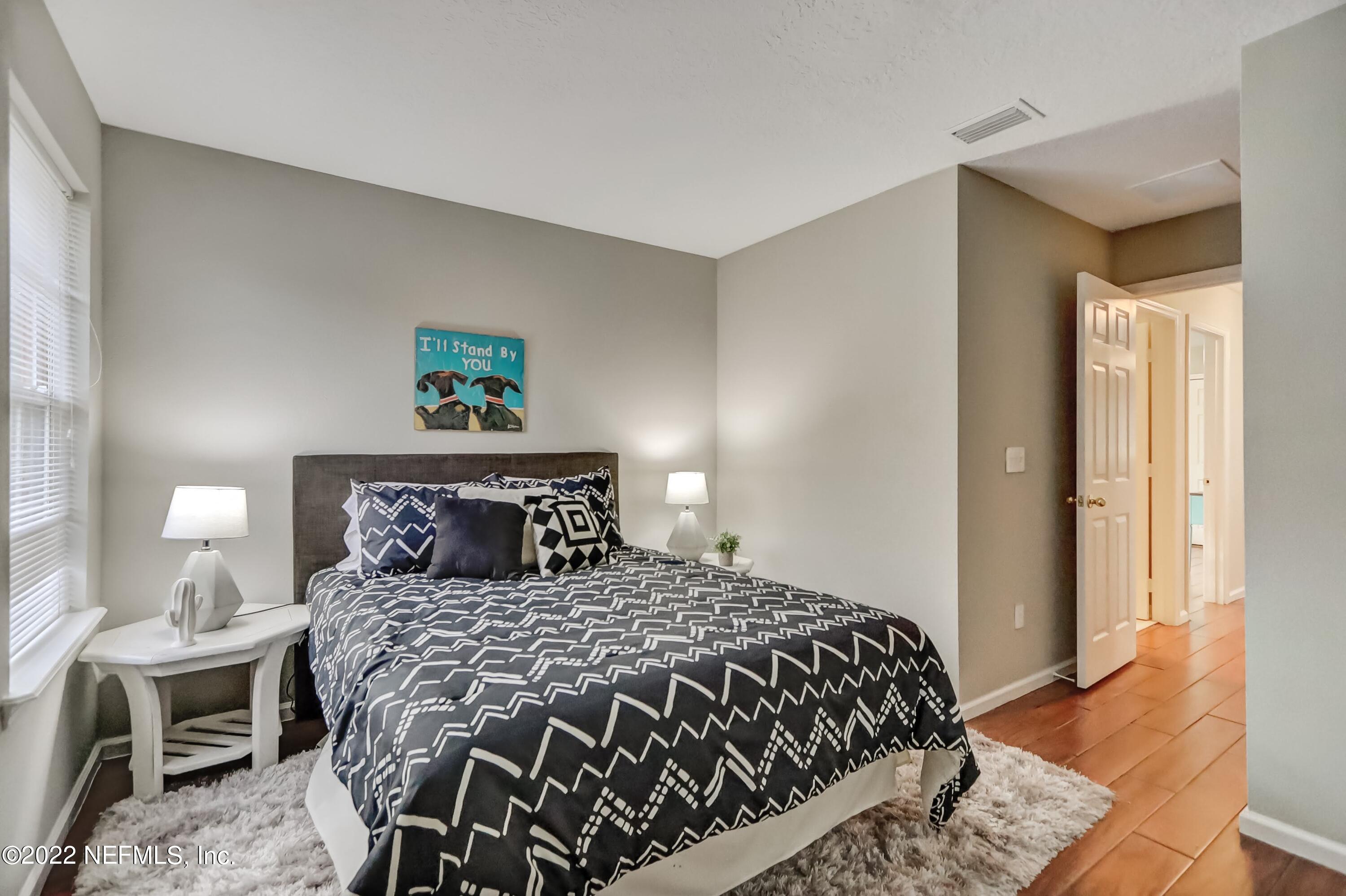 6849 Misty View Drive Jacksonville, FL 32210 - Photo 20 of 21 a bedroom with a bed and wooden floor