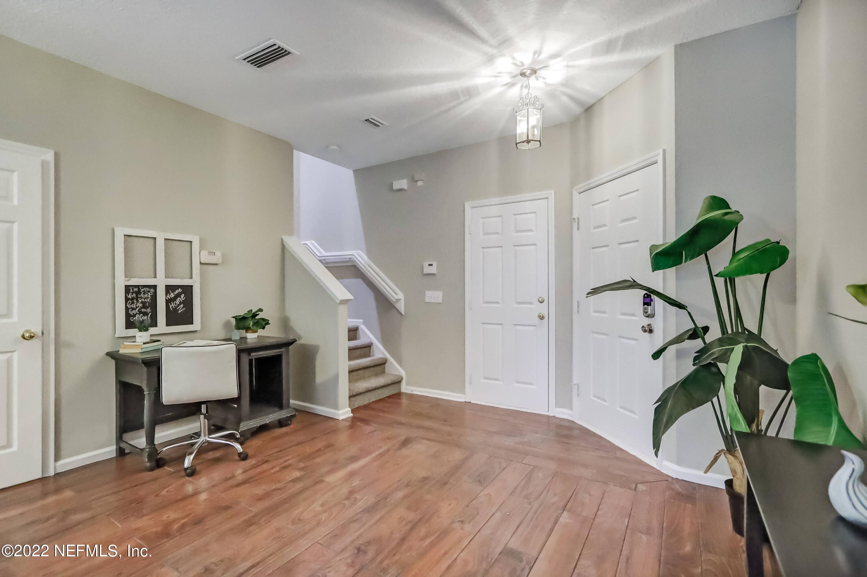 6849 Misty View Drive Jacksonville, FL 32210 - Photo 4 of 21 a view of a workspace with furniture and a potted plant