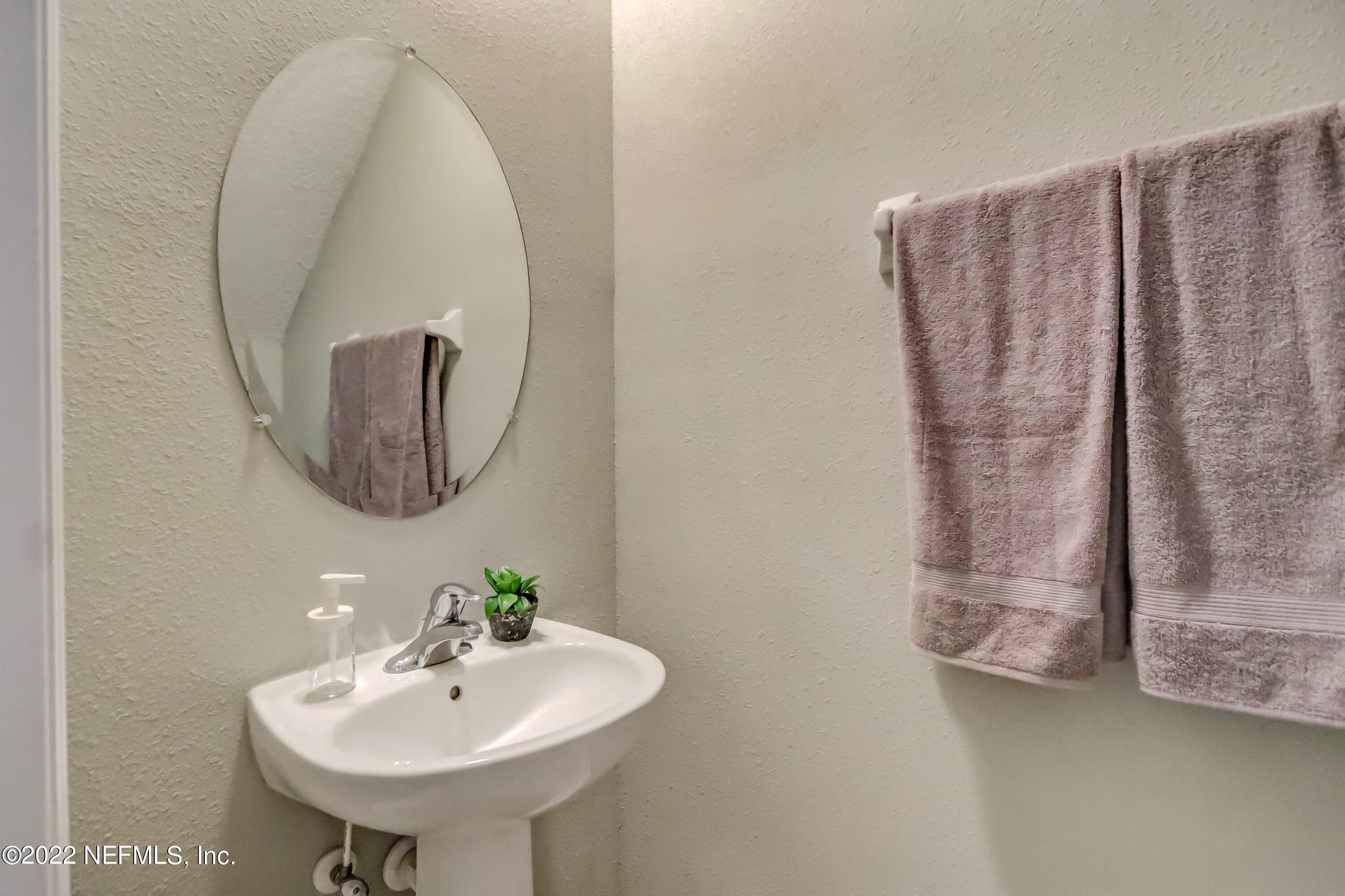 6849 Misty View Drive Jacksonville, FL 32210 - Photo 6 of 21 a bathroom with a sink and a mirror