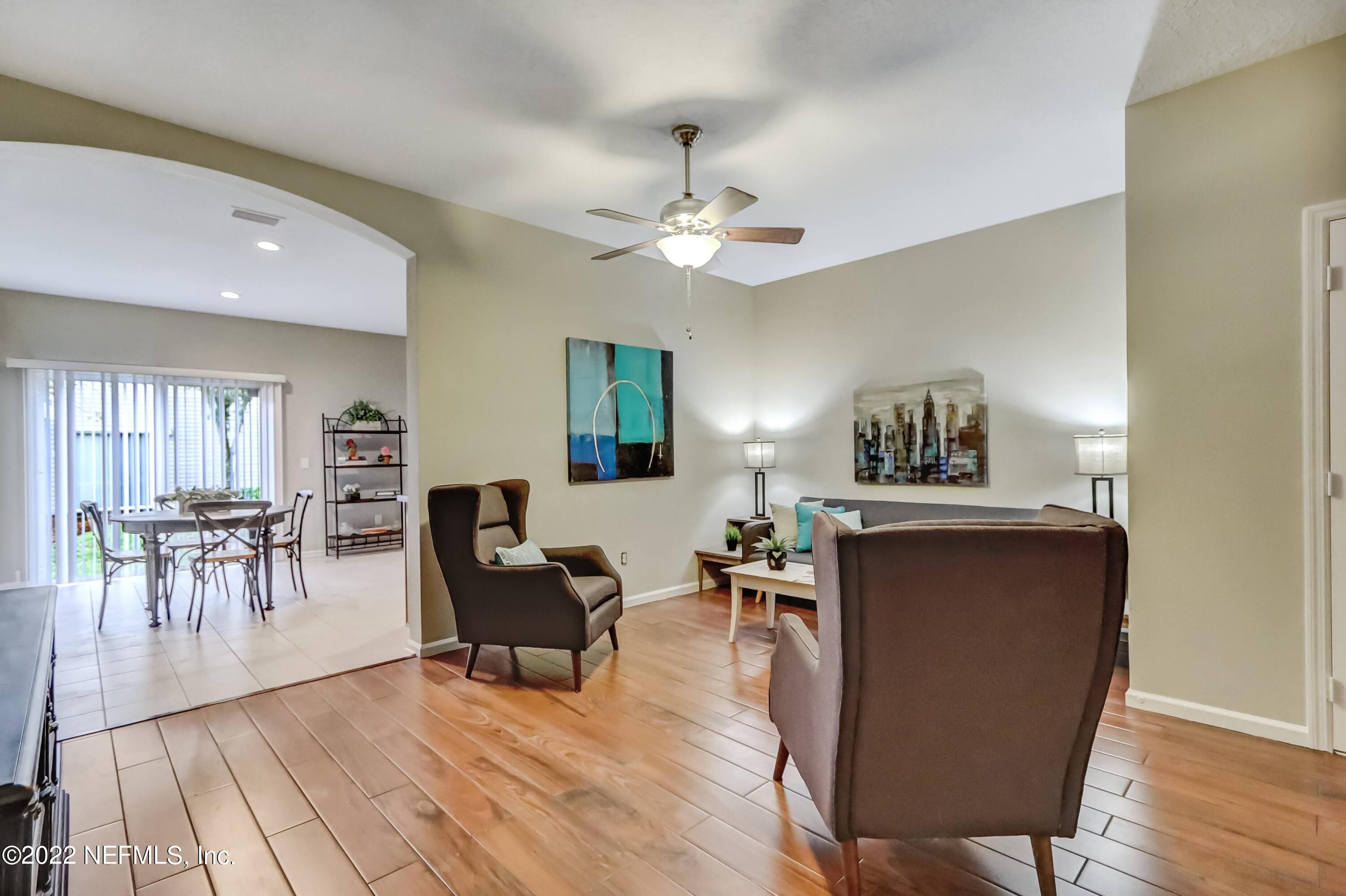 6849 Misty View Drive Jacksonville, FL 32210 - Photo 7 of 21 a living room with furniture a dining table and a piano table