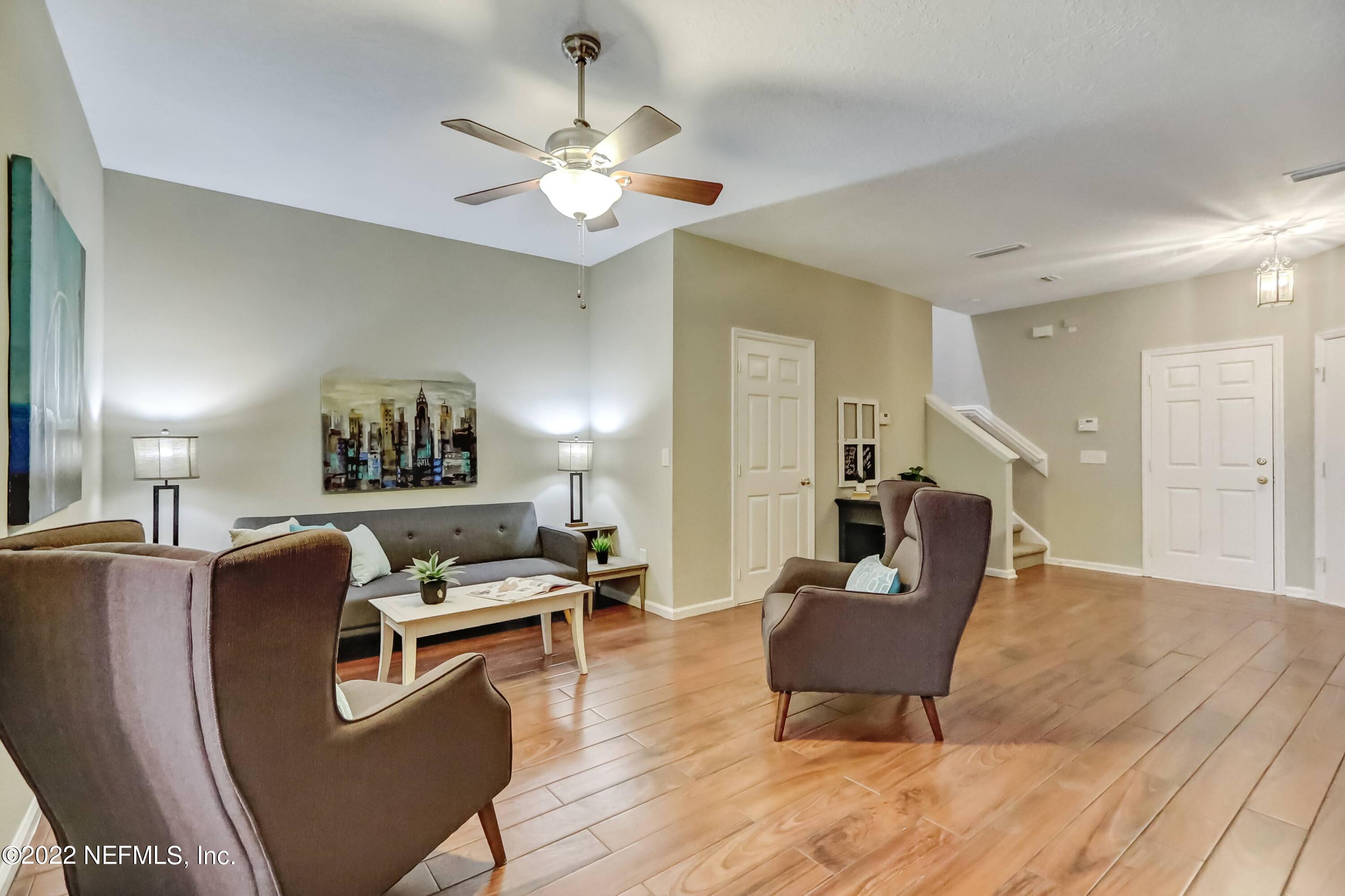 6849 Misty View Drive Jacksonville, FL 32210 - Photo 8 of 21 a living room with furniture and a chandelier