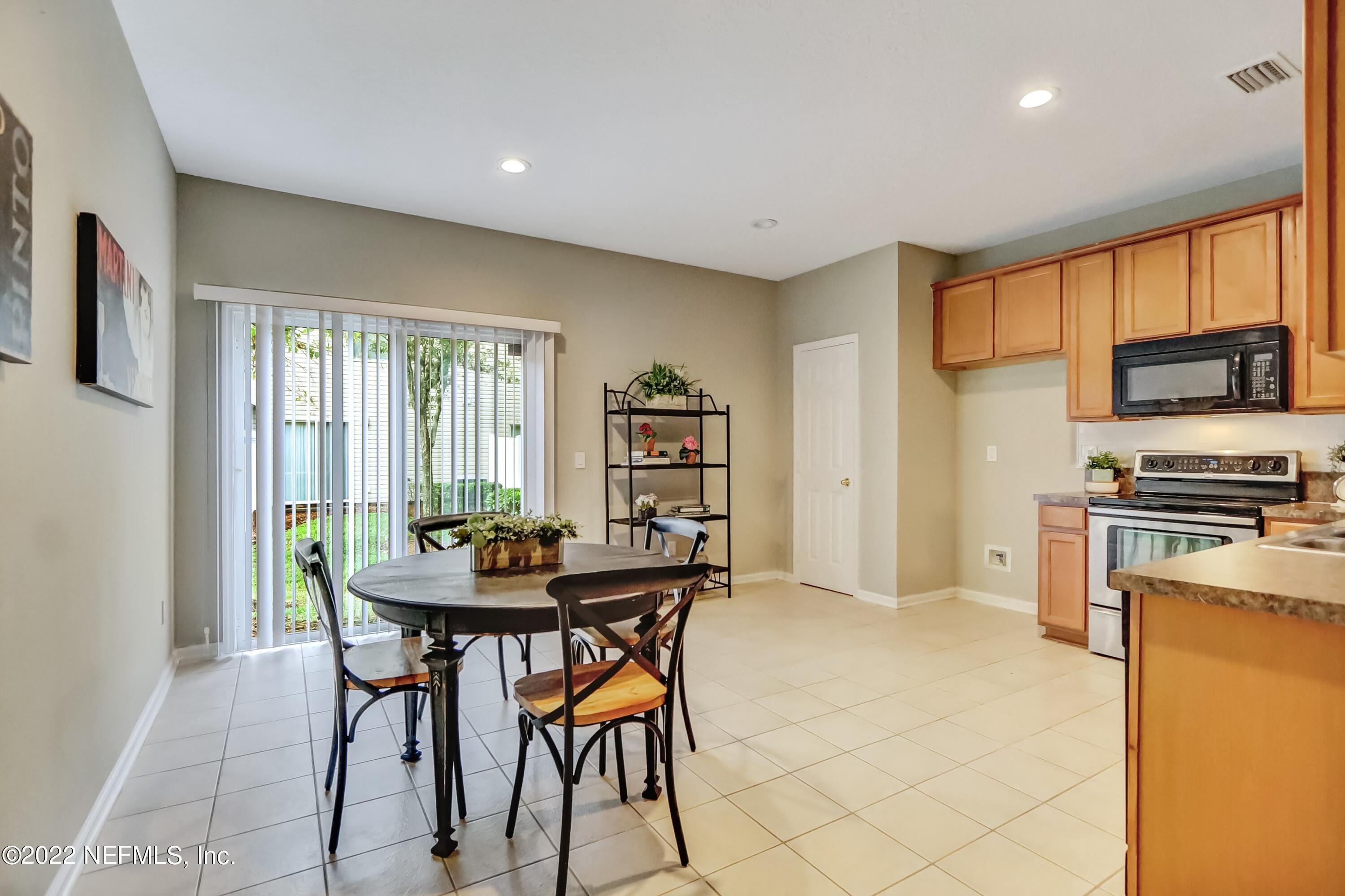 6849 Misty View Drive Jacksonville, FL 32210 - Photo 9 of 21 a kitchen with a table and chairs in it