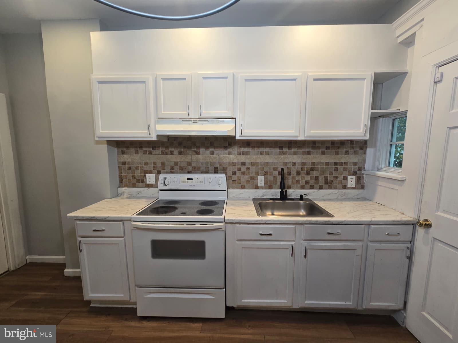 2430 Reisterstown Road Baltimore, MD 21217 - Photo 11 of 40 a kitchen with white cabinets and white appliances