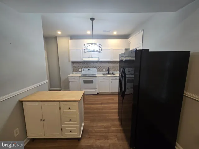 a kitchen with stainless steel appliances a refrigerator and a stove