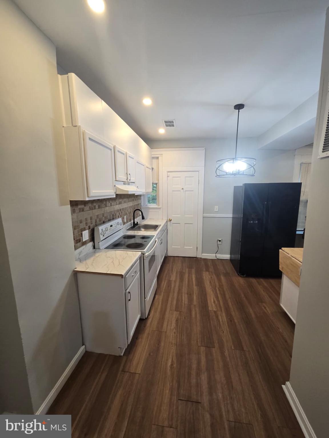 2430 Reisterstown Road Baltimore, MD 21217 - Photo 14 of 40 a kitchen with sink a refrigerator and wooden floor