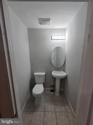 a bathroom with a toilet and a mirror