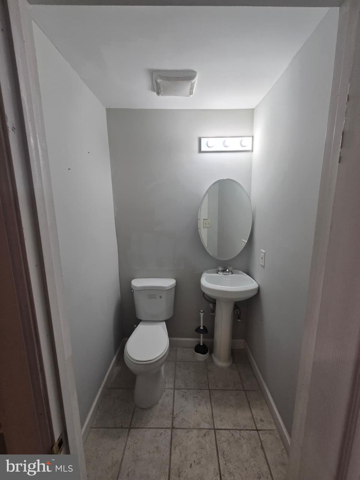 2430 Reisterstown Road Baltimore, MD 21217 - Photo 15 of 40 a bathroom with a toilet and a mirror