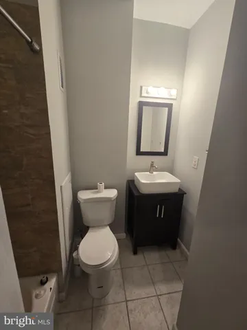 a bathroom with a toilet a sink and mirror