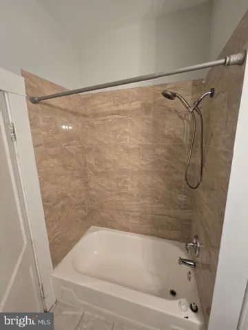 a bathroom with a shower and a bath tub