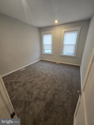 an empty room with wooden floor