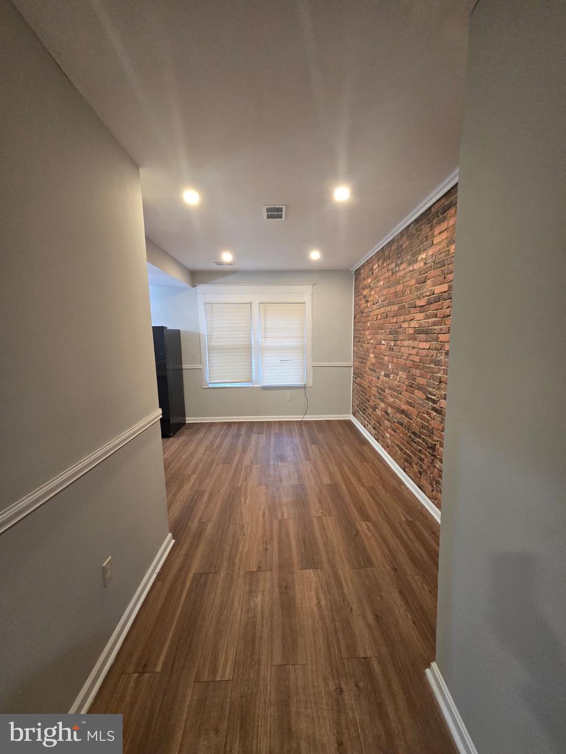 2430 Reisterstown Road Baltimore, MD 21217 - Photo 9 of 40 a view of empty room with wooden floor and fan