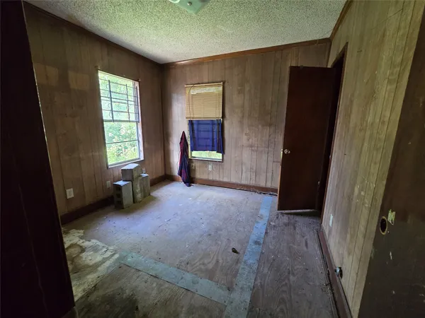 an empty room with windows and closet