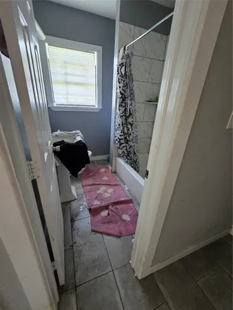 a bedroom with a rug and a window