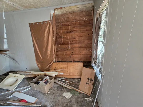 a view of water heater room with wooden floor