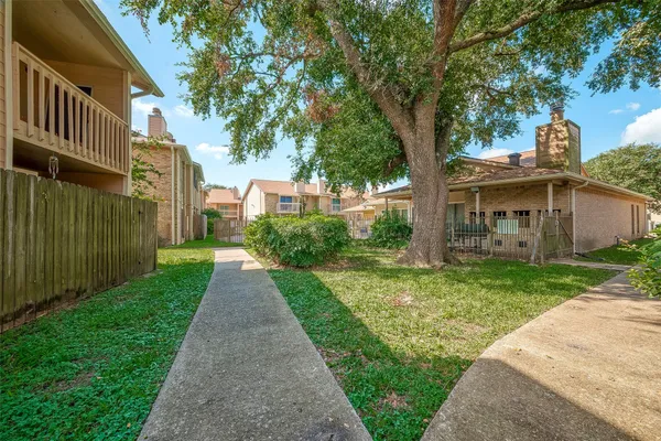 a view of a house with a yard and sitting area