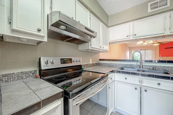 a bathroom with a granite countertop sink shower and a mirror