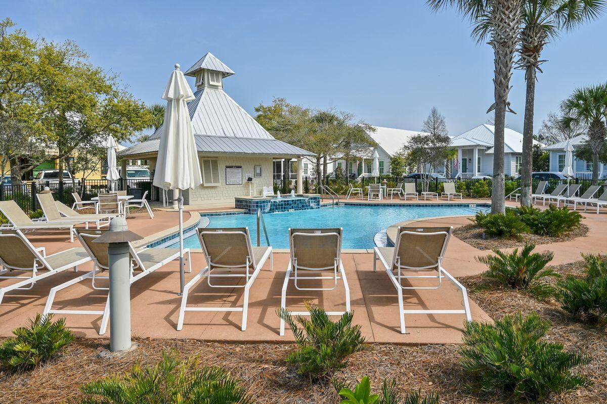 Lot 87 Cypress Drive Santa Rosa Beach, FL 32459 - Photo 39 of 39 a view of a patio with table and chairs potted plants and a large tree