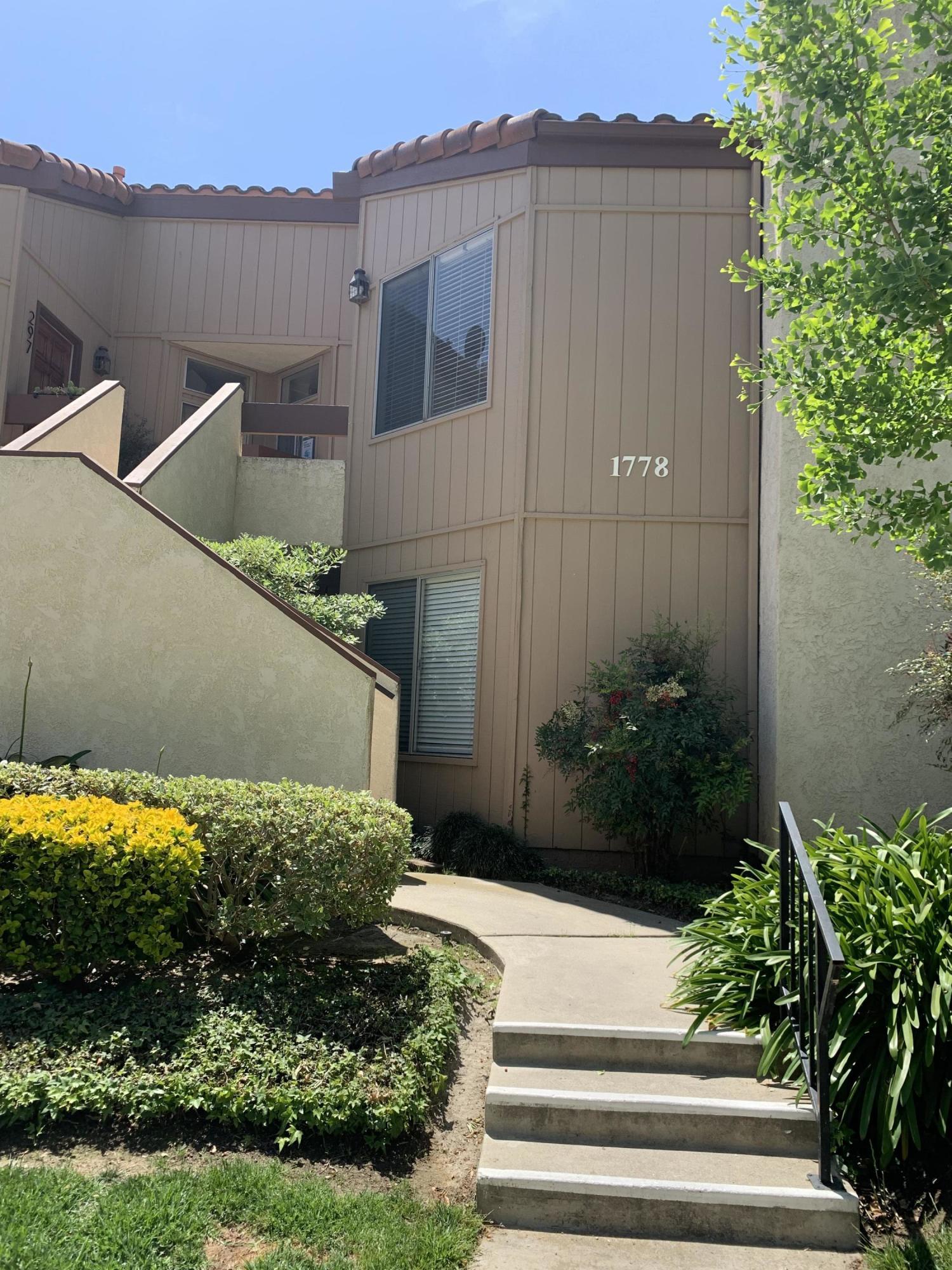 1778 Sinaloa Road, Unit 298 Simi Valley, CA 93065 - Photo 2 of 43 a front view of a house with a yard