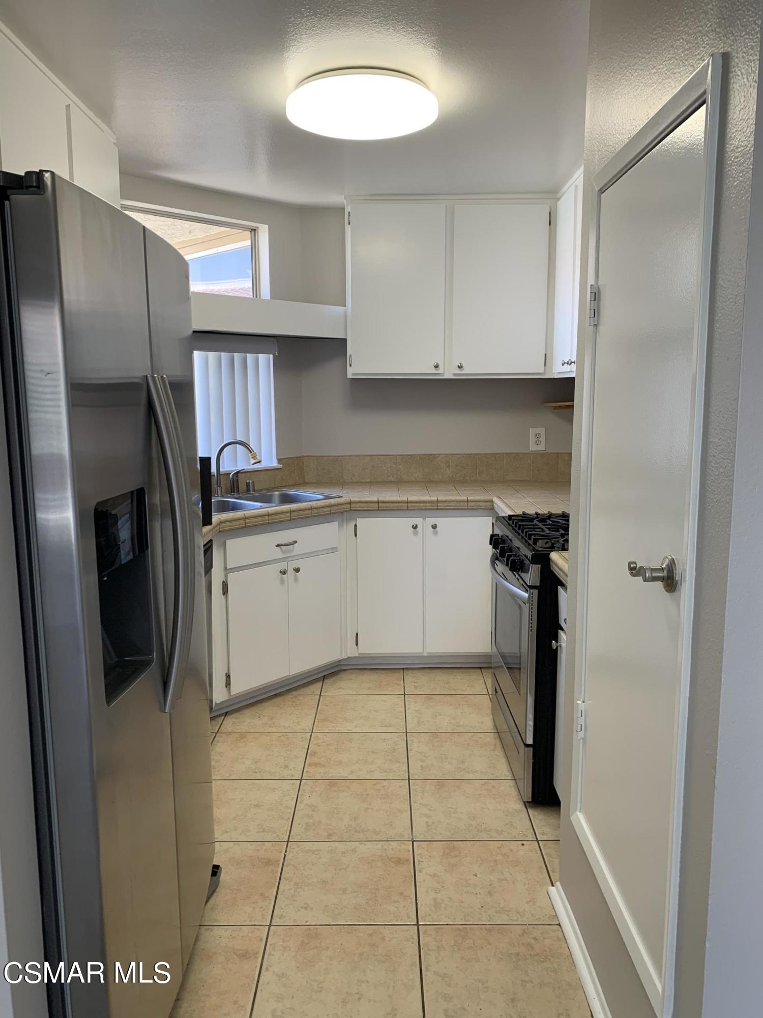 1778 Sinaloa Road, Unit 298 Simi Valley, CA 93065 - Photo 12 of 43 a kitchen with stainless steel appliances granite countertop a refrigerator and a sink