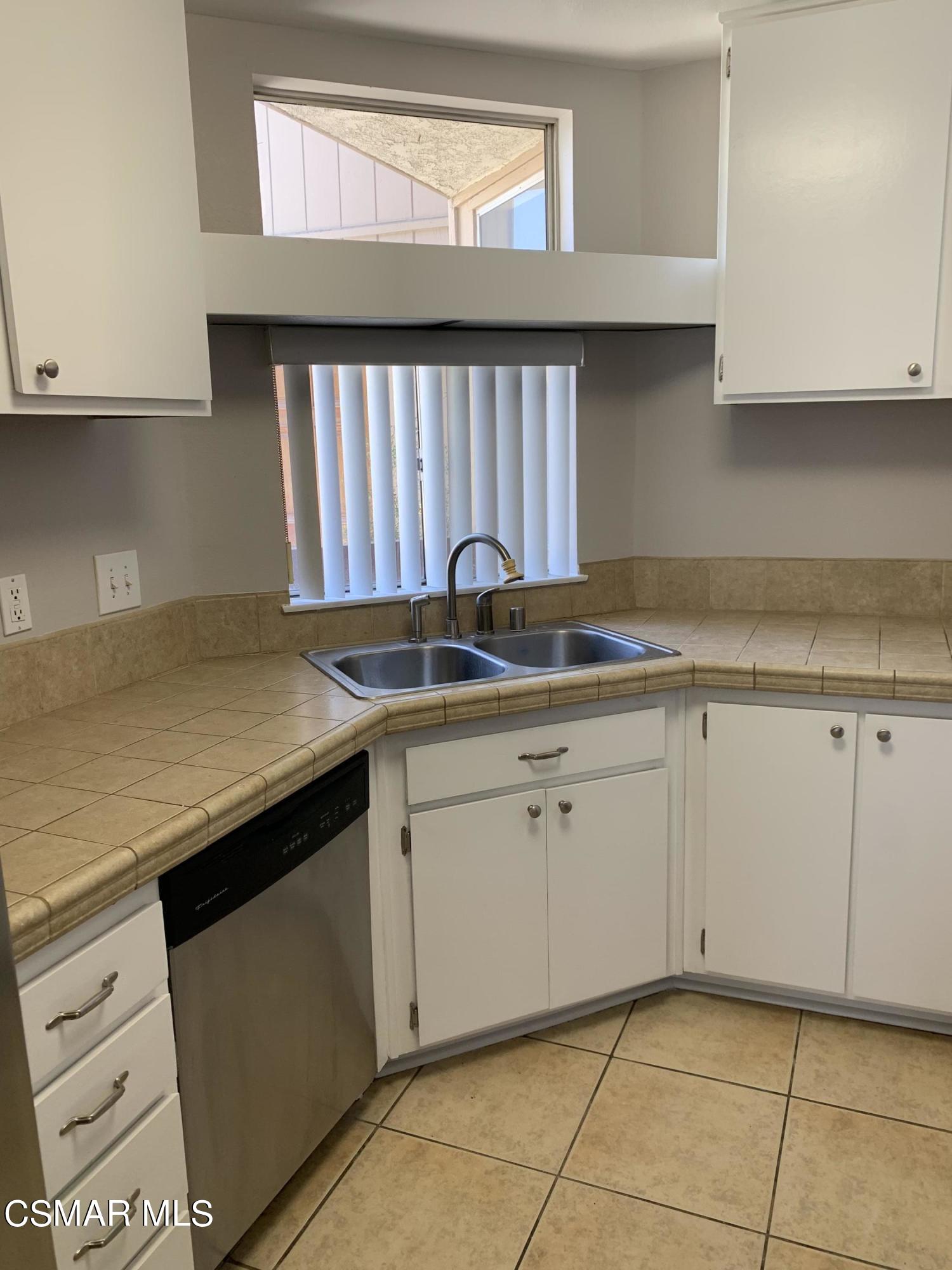 1778 Sinaloa Road, Unit 298 Simi Valley, CA 93065 - Photo 13 of 43 a kitchen with granite countertop a sink and a stove