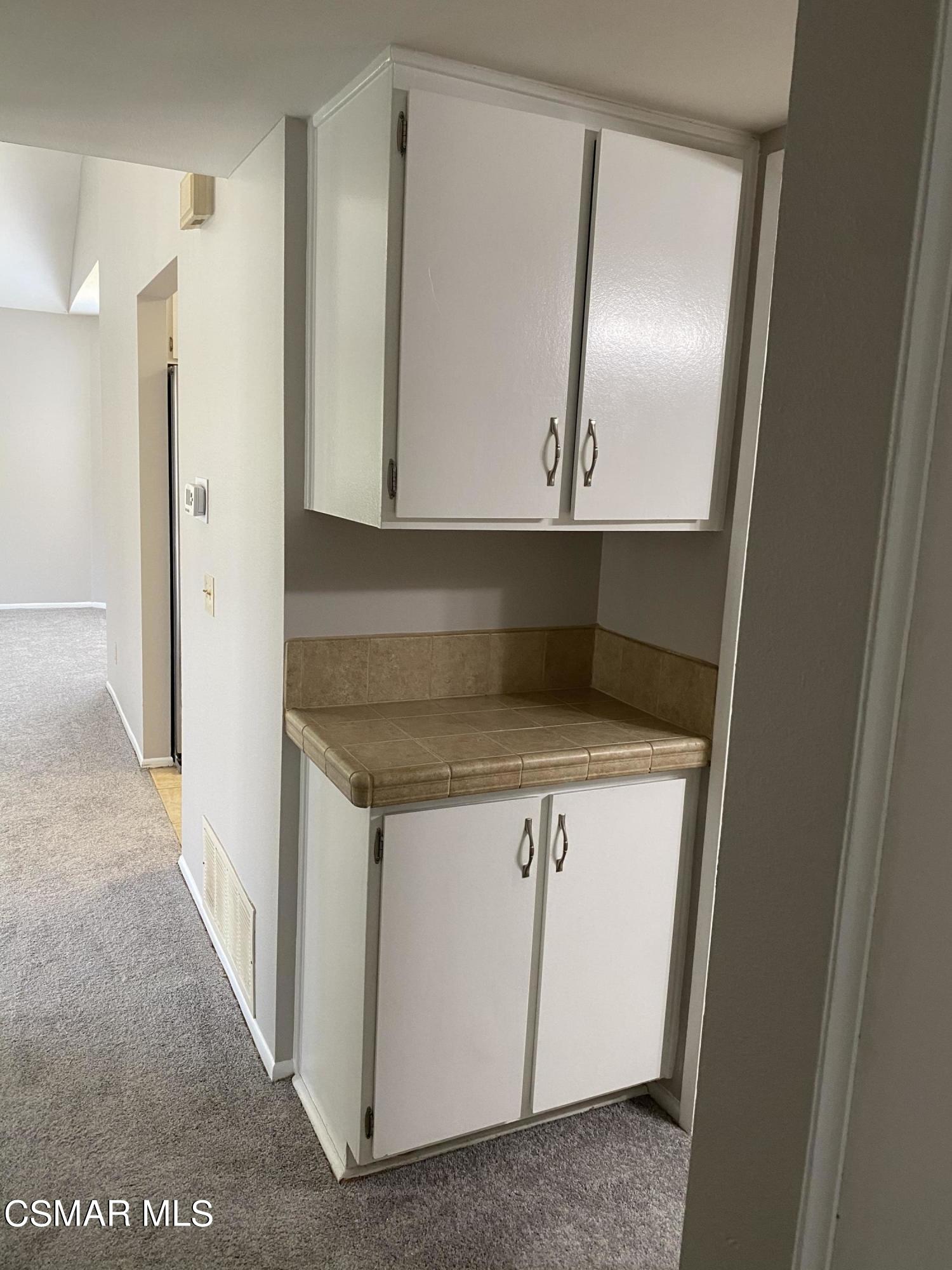 1778 Sinaloa Road, Unit 298 Simi Valley, CA 93065 - Photo 17 of 43 a kitchen with granite countertop a sink and a refrigerator