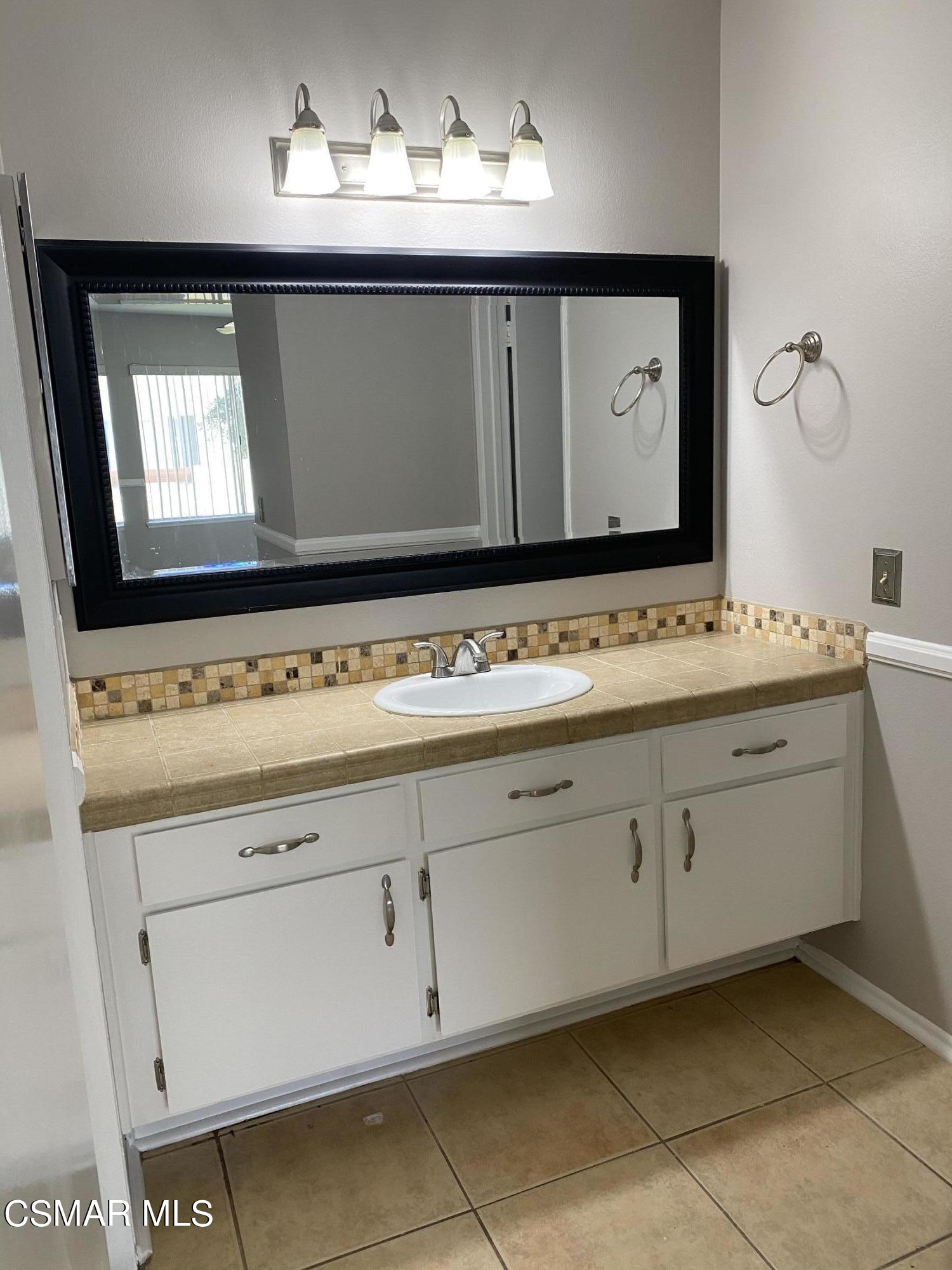 1778 Sinaloa Road, Unit 298 Simi Valley, CA 93065 - Photo 28 of 43 a bathroom with a sink and a mirror