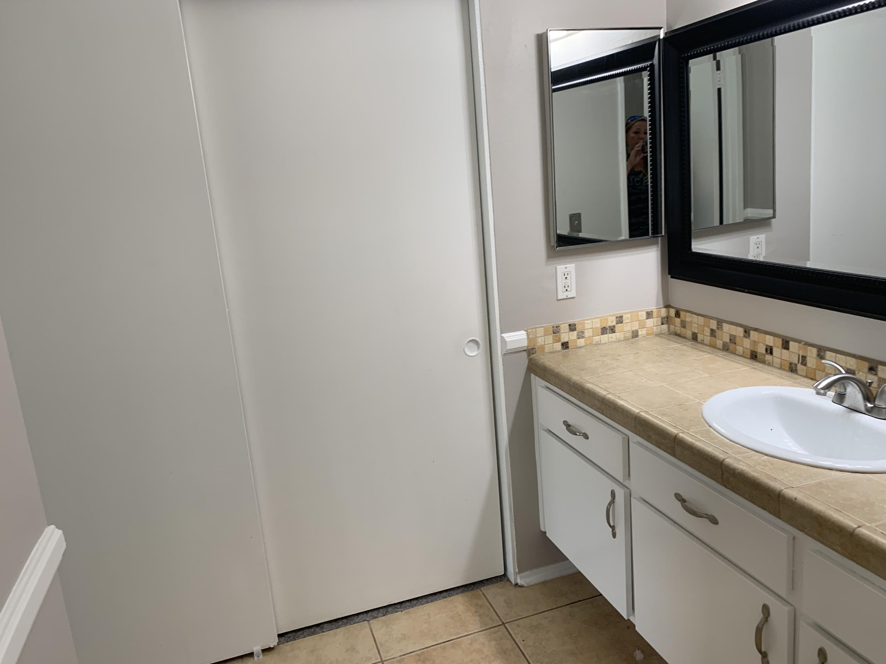 1778 Sinaloa Road, Unit 298 Simi Valley, CA 93065 - Photo 31 of 43 a bathroom with a sink and a mirror