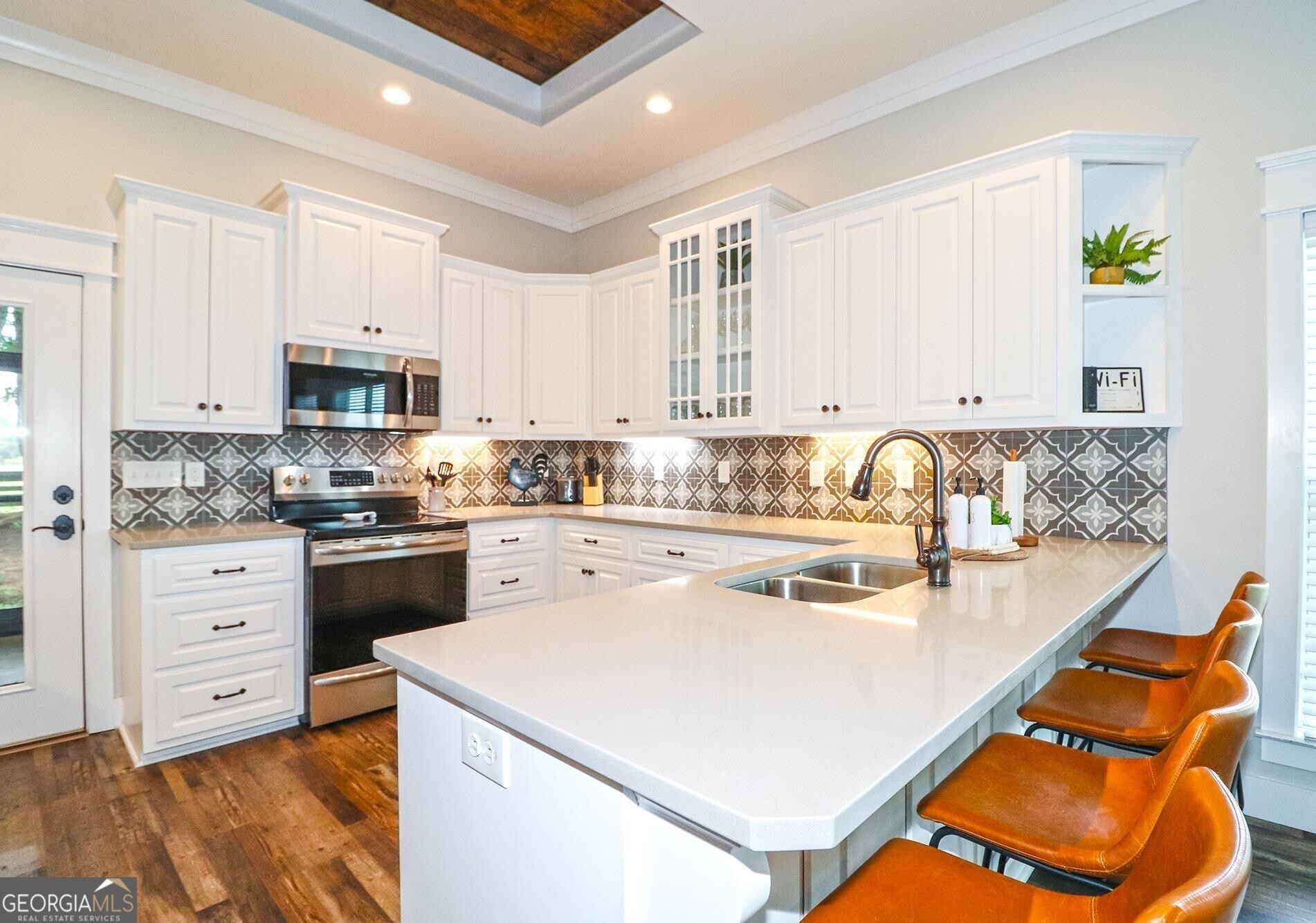 1603 Boutwell Road Perry, GA 31069 - Photo 11 of 96 a kitchen with a stove a sink and a refrigerator