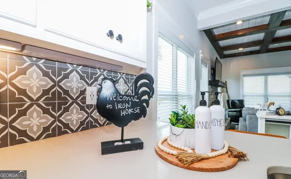 a en suite bathroom with a granite countertop sink and a mirror