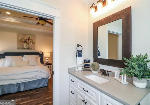 a bathroom with a granite countertop sink and a mirror