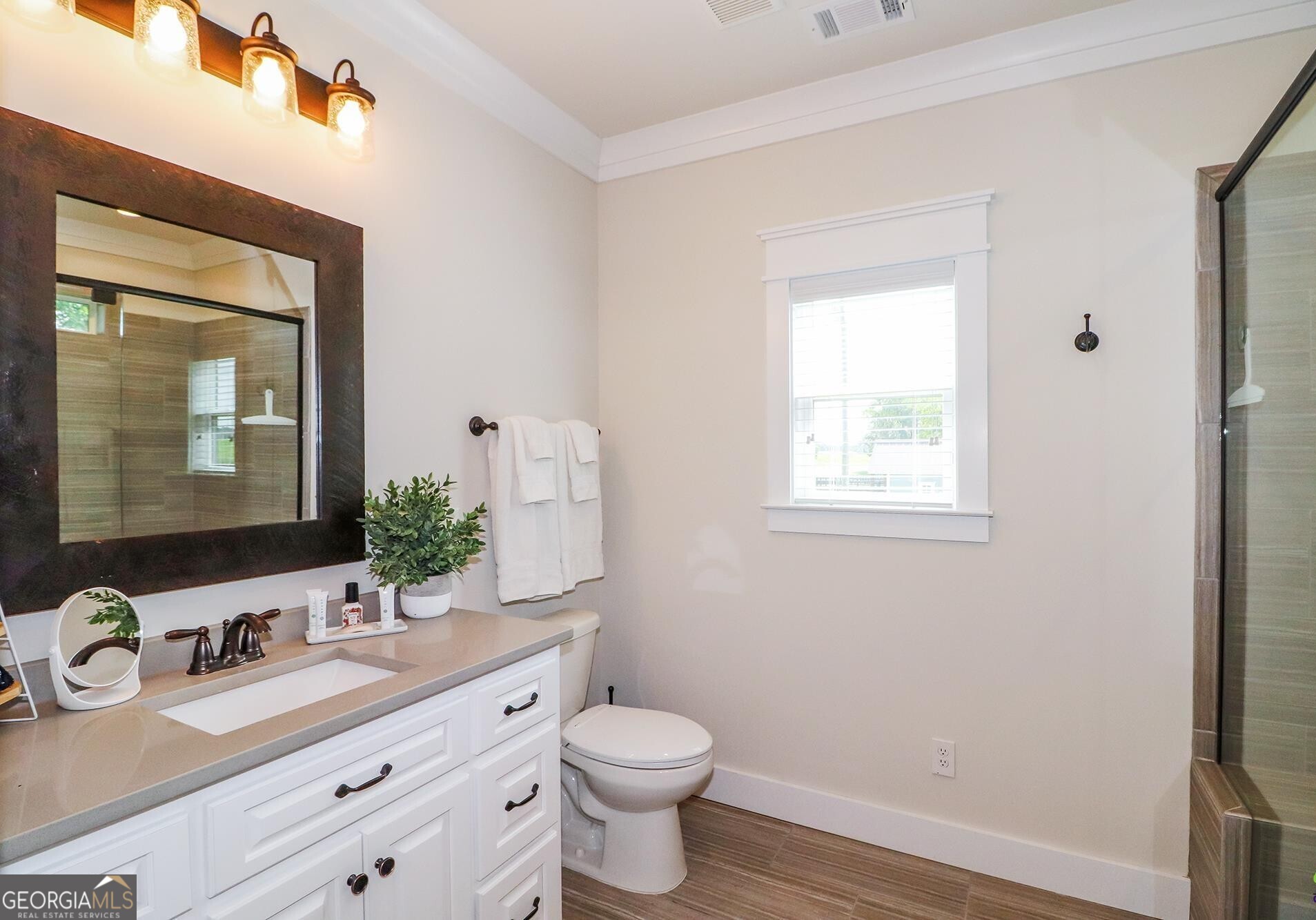 1603 Boutwell Road Perry, GA 31069 - Photo 24 of 96 a bathroom with a granite countertop toilet a sink and a mirror