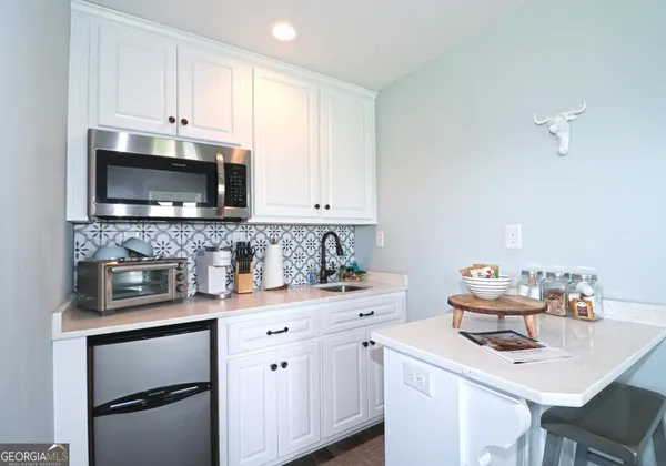 a kitchen with stainless steel appliances kitchen island granite countertop a sink and a stove