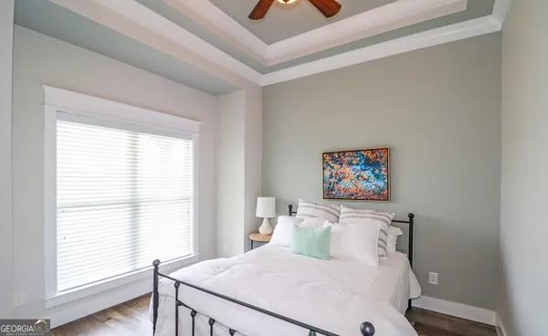 a living room with stainless steel appliances kitchen island granite countertop wooden floors and fireplace