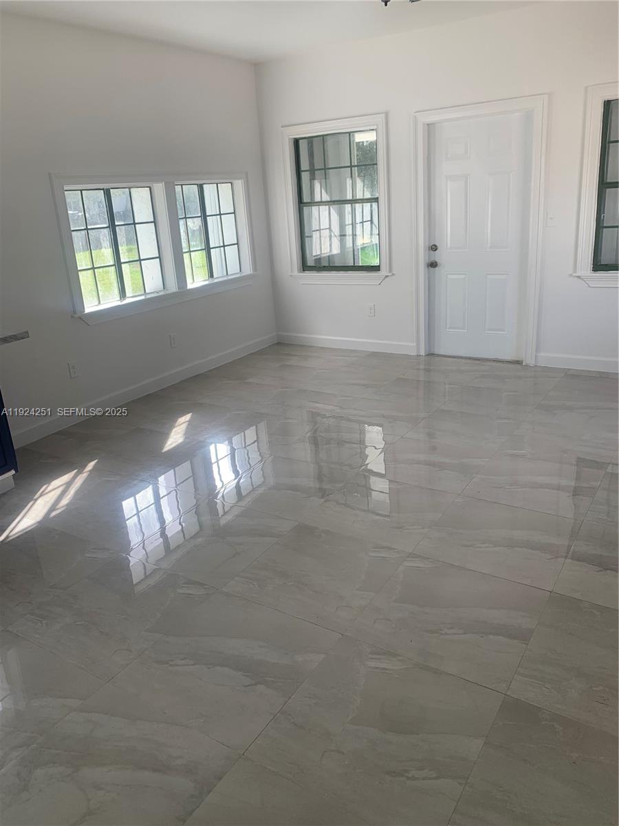 30900 Southwest 189th Avenue, Unit 2 Homestead, FL 33030 - Photo 3 of 7 a view of an empty room and window