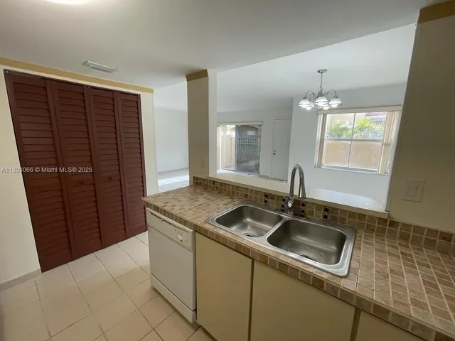 a kitchen that has a sink and a stove in it