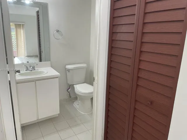 a bathroom with a toilet a sink and vanity