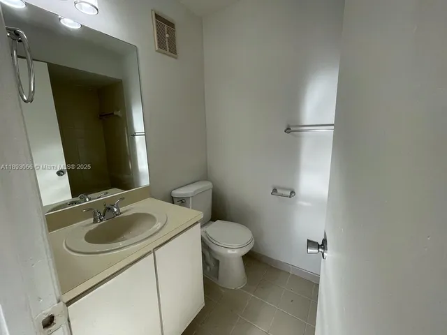 a bathroom with a sink toilet and mirror