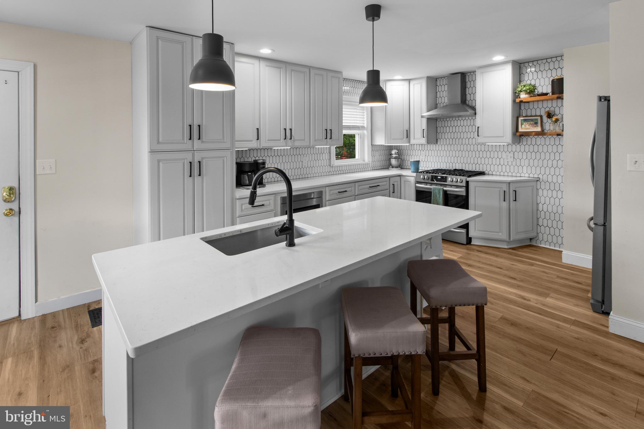 529 Ridge Road Southampton, NJ 08088 - Photo 9 of 25 a kitchen with stainless steel appliances a table chairs sink and cabinets