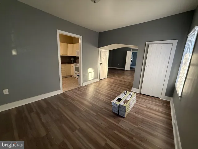 a living room with hard wood floors and a wooden floor