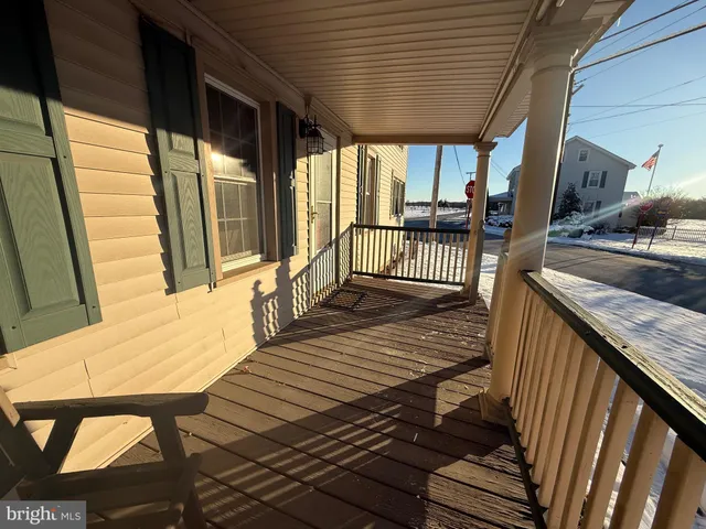a view of balcony with wooden floor