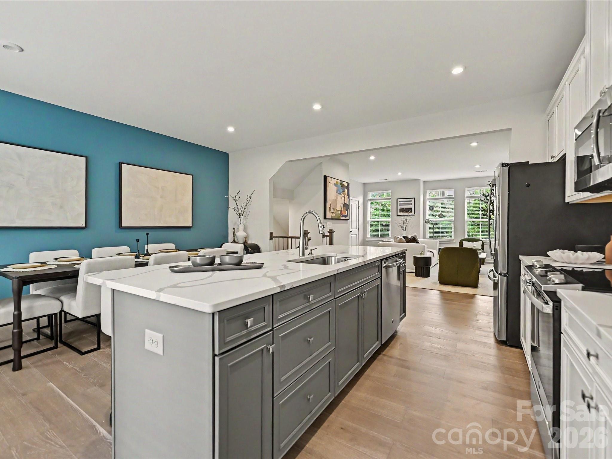 653 Uwharrie River Road Charlotte, NC 28211 - Photo 11 of 29 a large kitchen with kitchen island a sink a stove a center island a dining table and chairs