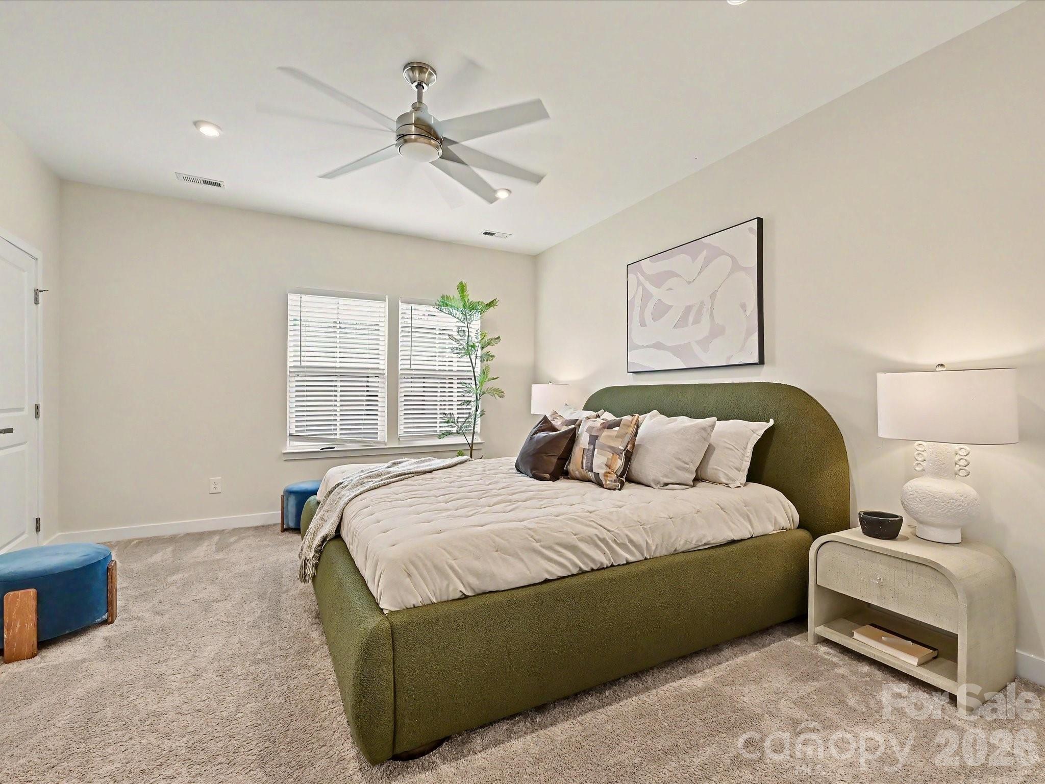 653 Uwharrie River Road Charlotte, NC 28211 - Photo 14 of 29 a bedroom with a large bed and a couch