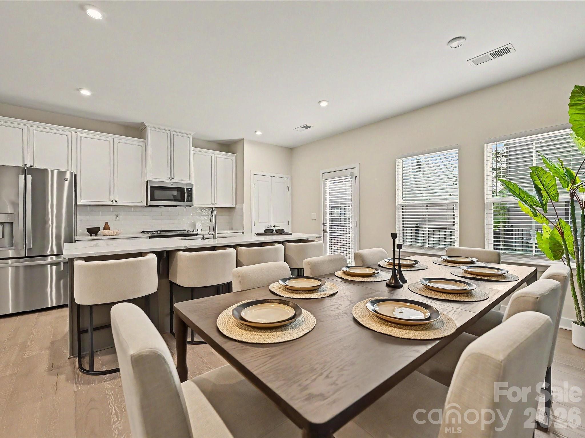 653 Uwharrie River Road Charlotte, NC 28211 - Photo 8 of 29 a kitchen with a table chairs stove and refrigerator