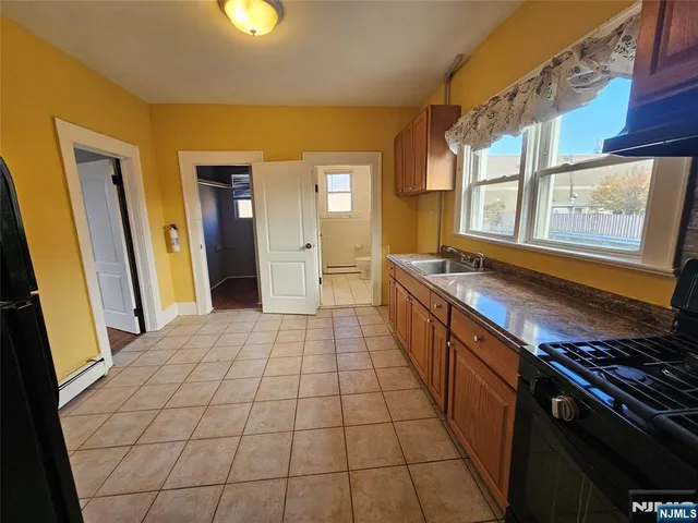 a kitchen with a sink and a stove top oven