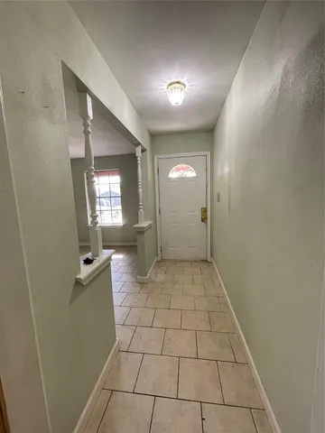 en empty room with mirror and tiles