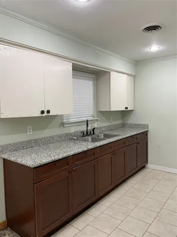 a bathroom with a granite countertop sink and mirror