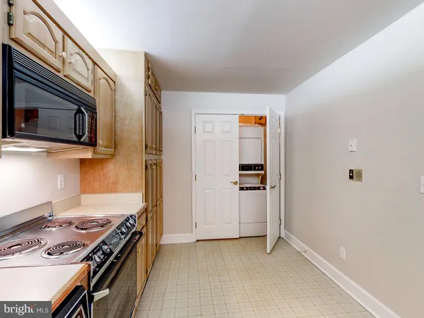 a kitchen with stainless steel appliances a stove and a microwave